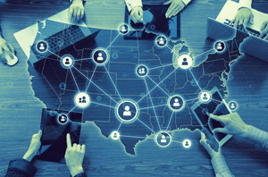 A group of people working on a table Description automatically generated