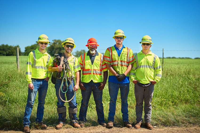 five Charter technicians wearing hardhats and safety vests